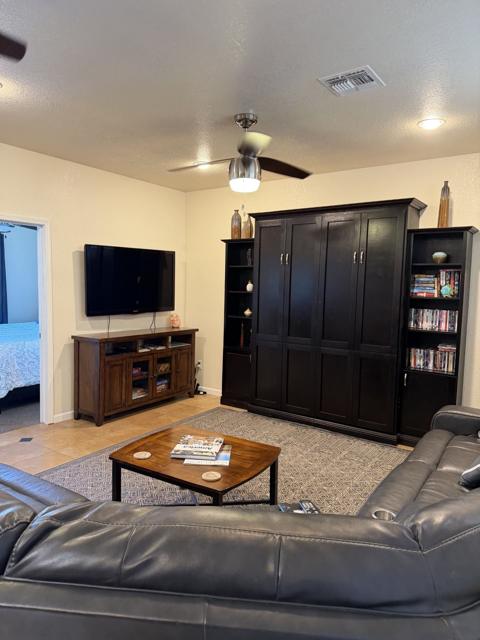 Living room: The taller bookshelf conceals the murphy bed which pulls down into the living room at night.