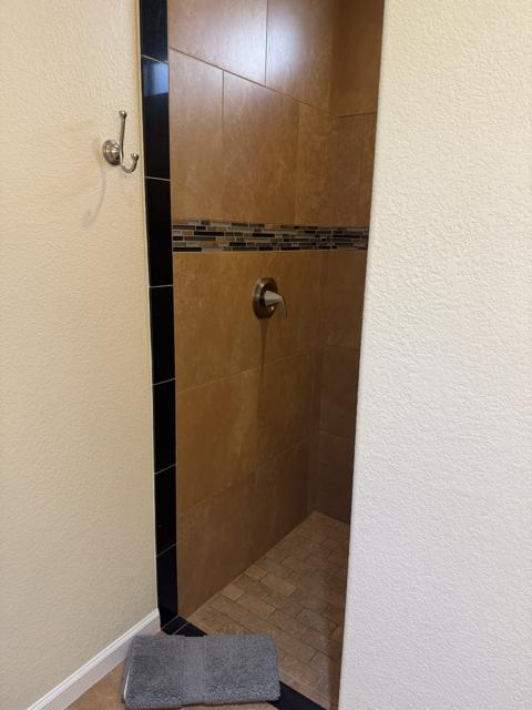 Full bathroom: Fully tiled, walk-in shower with bench.