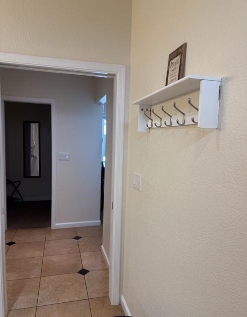Full bathroom: View from shower entry. Walk in Closet across hallway with full sized mirror and plenty of space for your things. Immediately to the left are the washer and dryer.
