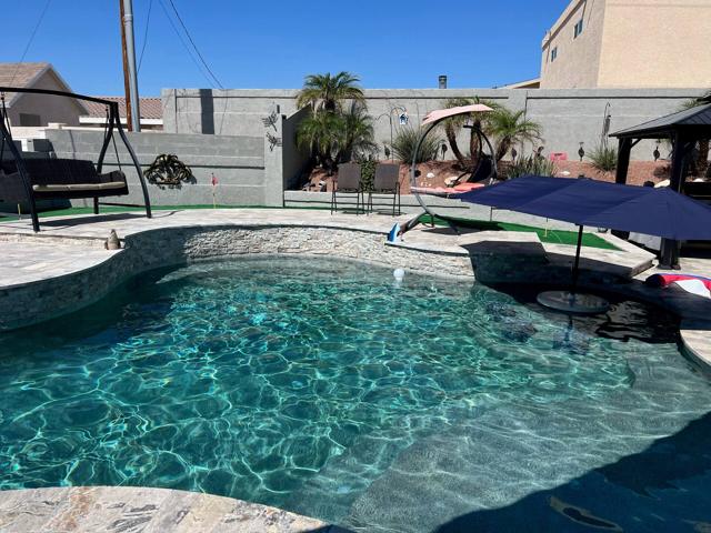 Backyard: Sparkling Heated Pool. Mini Golf available behind pool. Plenty of seating and relaxation/shade.